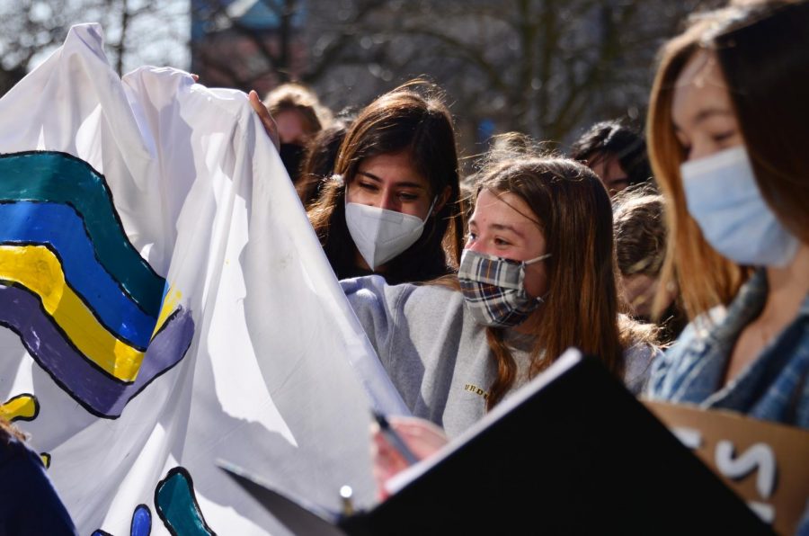 STATEHOUSE STRIKE: Juniors Sage Mehta (left) and Lisa Venckus (middle) hold up a banner at a climate strike on March 19, 2021. At the strike, students across the state declared a climate emergency and requested a meeting with Gov. Holcomb to discuss Indianas role in climate action.
