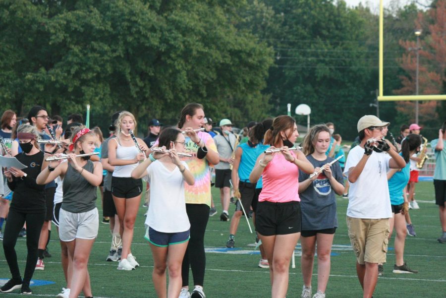 The flute section moves in formation together during rehearsal. They practice their music and the moves at the same time, putting it together with the rest of the band. Social distancing is enforced as much as possible.  