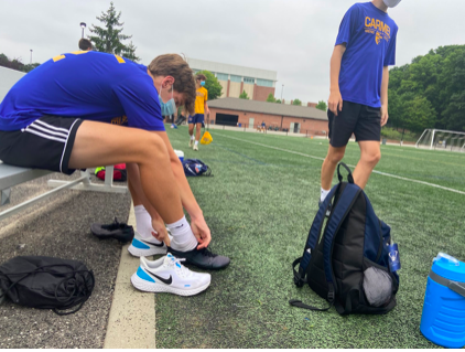 Members of the men’s varsity soccer team put on their gear and get ready for practice. Chase Havice, men’s varsity soccer player and junior, said not too much has changed from before the pandemic and he believes he has a really good team this year.
