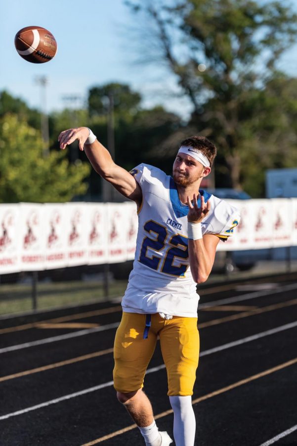 Colton Parker, varsity football wide receiver and senior, warms up before a home game against Center Grove on Sept. 4. The varsity football team will play their next game at Carmel Stadium against Ben Davis on Oct. 2.