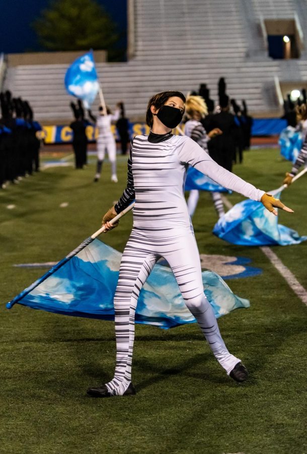 Samantha Yarborough, color guard member and freshman, performs in the last show of the year on Oct. 24. The show, titled Tribute, was a medley of five different championship-winning shows performed by the marching band and guard in prior years.