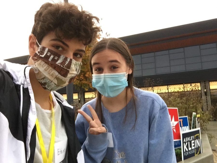 Juniors Ethan Stoehr (left) and Clizia Martini (right) post in front of polling station. Martini said that "something that you should learn as a society, (which) is not to always follow your friends, or to follow your family, and to make your own independent views"