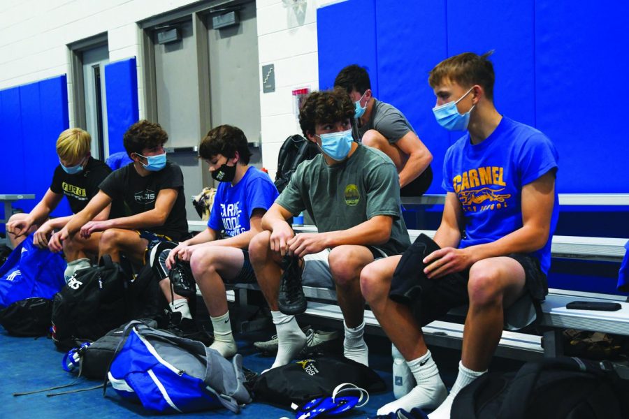 MASKS ON: 
Members of the wrestling team put on their gear before practice. Harel Halevi, varsity wrestler and senior, said he believes contracting the virus while wrestling is less likely than it seems because athletes meet only a few people at each meet on top of the many new safety procedures.