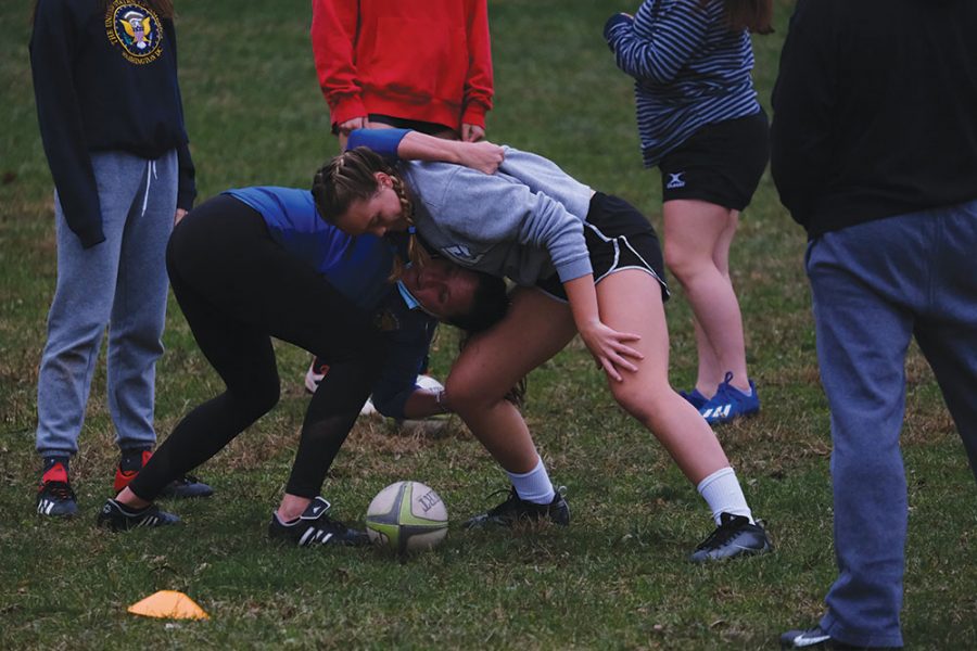 Celia Watson, Rugby Club member and sophomore, trains with women’s rugby coach Kelly Teresa during practice on Oct. 28. Watson said playing rugby was influenced by her experience playing college-level flag football in Brazil.