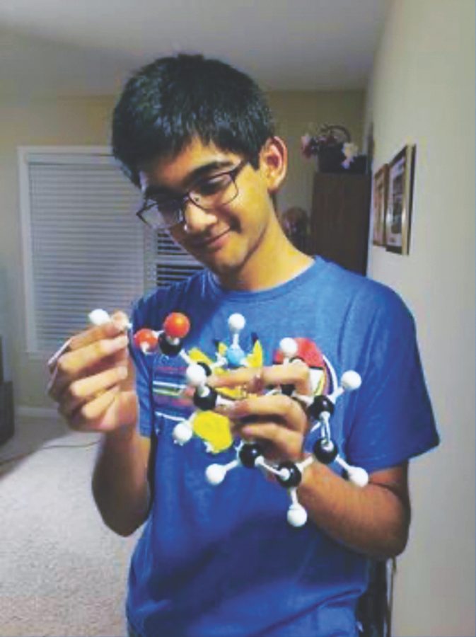 Junior Labeeb Hossain analyzes his protein model of the amino acid phenylalanine at his home.Hossain said he is aware there are some conflicts between religious and scientific doctrines, but said he is open to modifying his beliefs to accept scientific facts. 