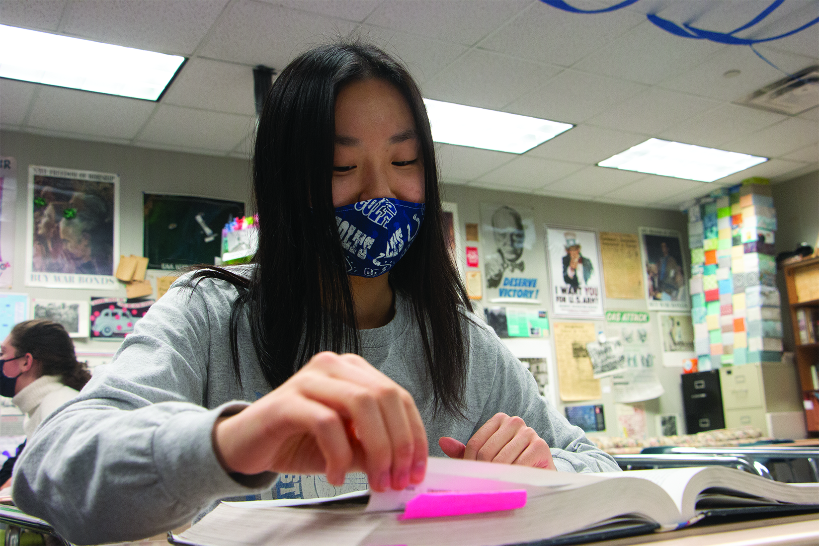 Junior Claire Qu quickly studies for her AP U.S. History final during passing period. Qu said that finals week was especially stressful given her course schedule.