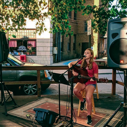 Musician and sophomore Celia Watson performs her own songs in Downtown Indianapolis in front of dining crowds. Watson recorded her first album, consisting of three songs, in 2020.

