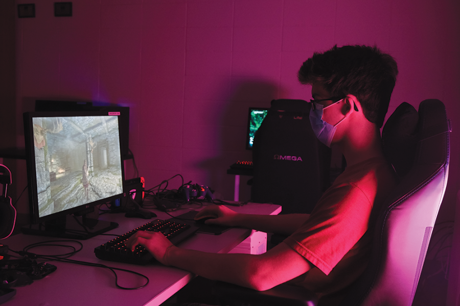 Dylan Boyer, eSports member and junior, sits in the eSports team’s new room playing Skyrim. Boyer said customization of characters allows players to express themselves in a subtle way.