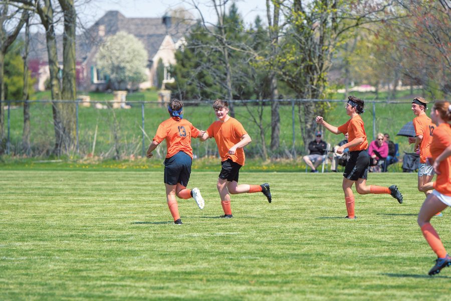 TERRIFIC TEAM: Junior Joey Duncan (second from left) fist bumps one of his teammates during his soccer game. Duncan said everyone is included when playing recreational soccer.