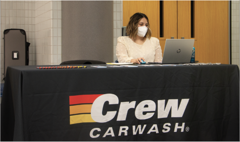 A representative for Mike’s Crew Carwash waits for students to arrive at her station at the job fair. The job fair was an opportunity for students to find and gain work experience while still in high school. 