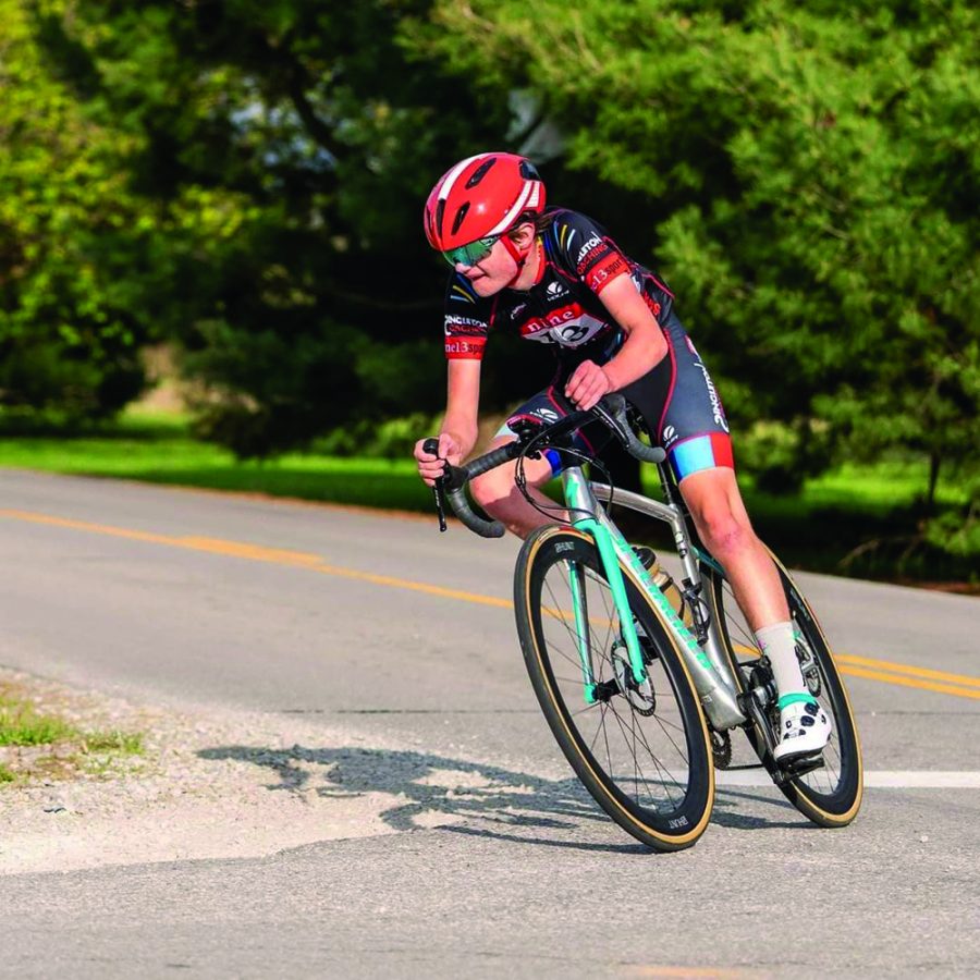Griffin Raduchel, competitive cyclist and junior, goes down a road on his road bike. Raduchel said competitive cycling has taught him to push himself further.
