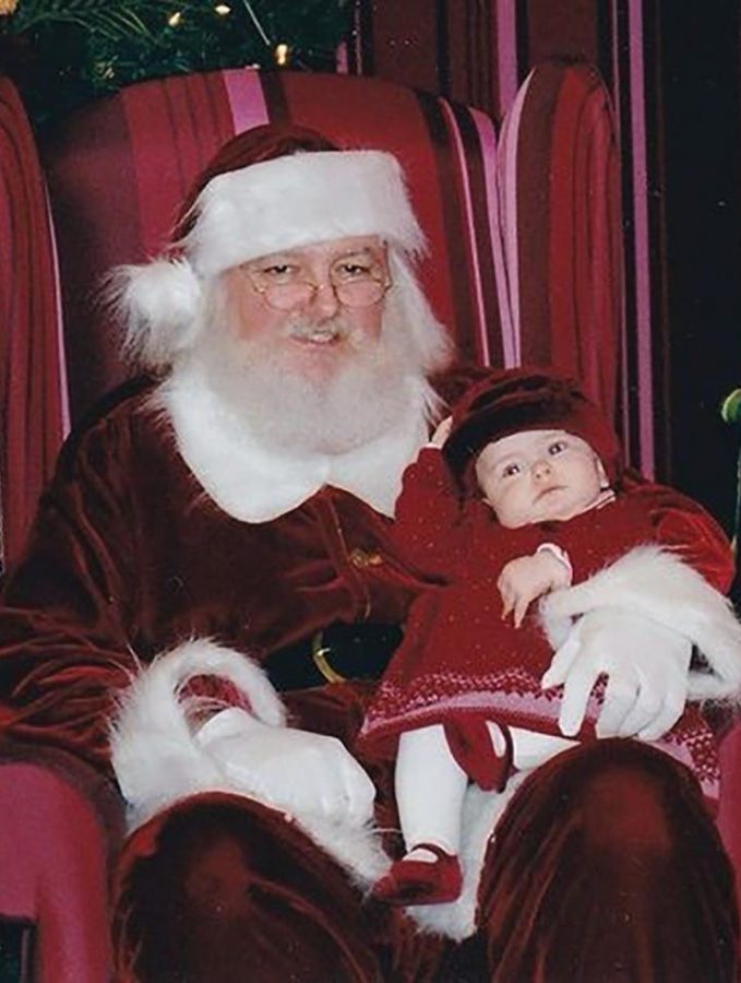 Senior Lillian Williams poses next to Santa Claus as a baby. She said even though her parents told her about Santa Claus, she never saw it as a lie. Williams said she will tell her own children about Santa Claus because she said she thinks it will be fun and will continue the tradition of good memories and gift-giving.