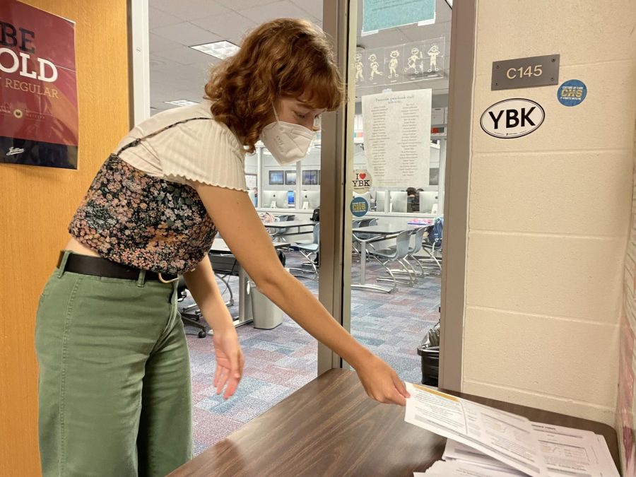 Naomi Grossman, Pinnacle editor in chief and senior, picked up a yearbook order form outside of Room C145. She said the order form directs students to order their yearbook online, as well as explaining pricing and other significant information. 