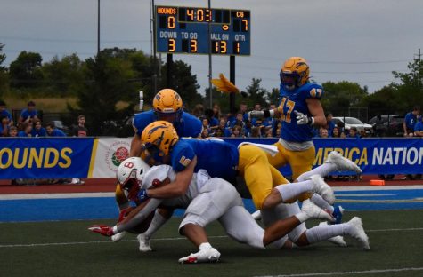 Junior Winston Berglund tackles a player from the Center Grove team at the home game on Sept. 3