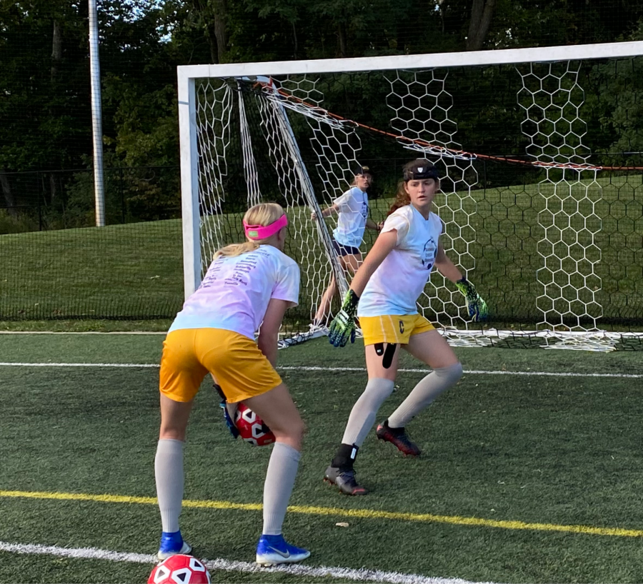 Goalkeeper and junior Bethany Ducat (right) prepares to save a ball about to be thrown by goalkeeper and junior Aubree Empie while warming up for a game against Warren Central on Sept. 15