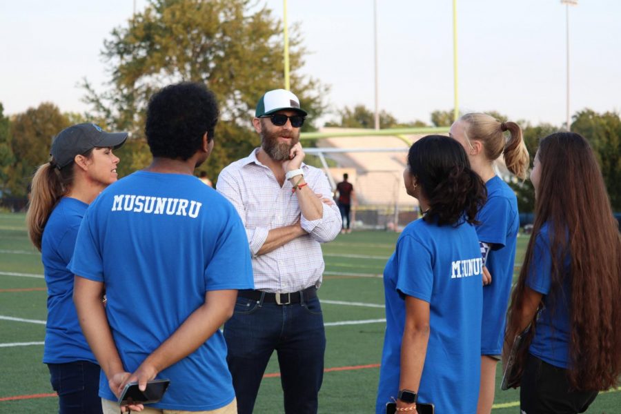 President Manav Musunuru talks with sponsors and other members of the Carmel Mayor's Youth Council (CMYC) about the logistics of the Ultimate Frisbee Tournament. The tournament was held on Sept. 10.