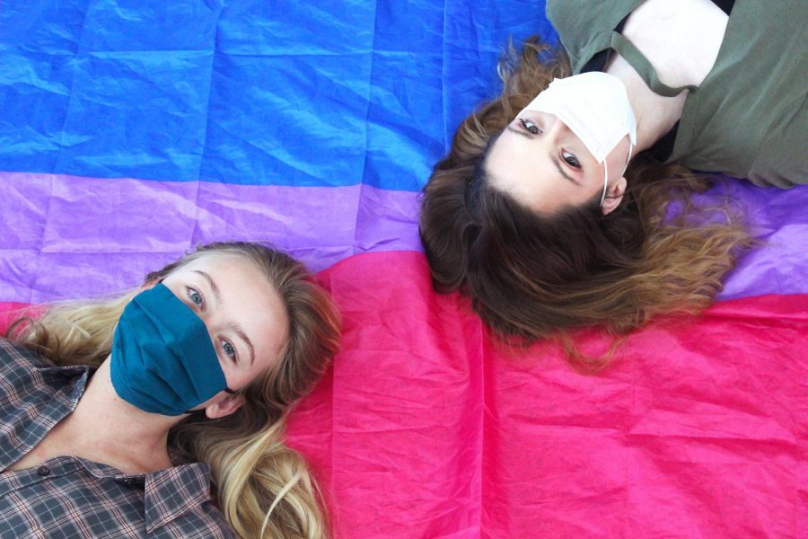 Junior Marielle Cortelyou and senior Annie Salter pose with a bisexual flag. Cortelyou, the president of the Gender and Sexuality Alliance, said she believed Bisexual Pride Day was a validating occasion.