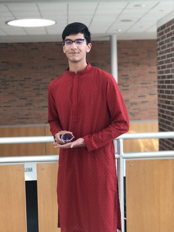 Sophomore Keshav Singh poses with a diya, or clay lamp. Singh said, “During Diwali, we light diyas around the house to symbolize the victory of good over evil.”