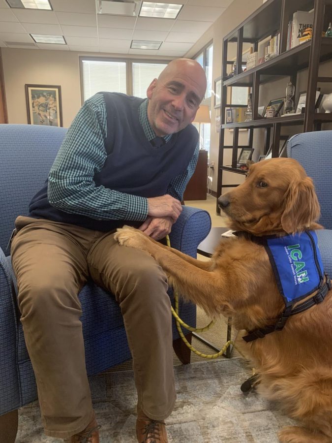  Superintendent Michael Beresford and Facility Dog Jim Dandee smile for the photo. According to Beresford, Dandee is adjusting well to his new role. 