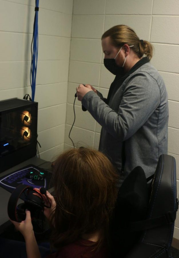 Dylan Gentilcore, Unified eSports team sponsor, fixes a student’s controller at an eSports meeting. Gentilcore said he looks foward to having an unstructured season and thinks the games played in Unified eSports are  going to be exciting for all Unified eSports participants.