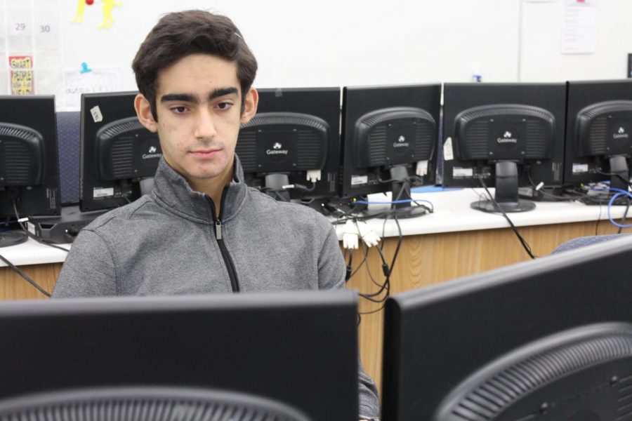 CyberPatriot member and sophomore David Racovan accesses a computer. Racovan said cybersecurity helps protect data and privacy and helps students stay aware of what they post online and who views it.