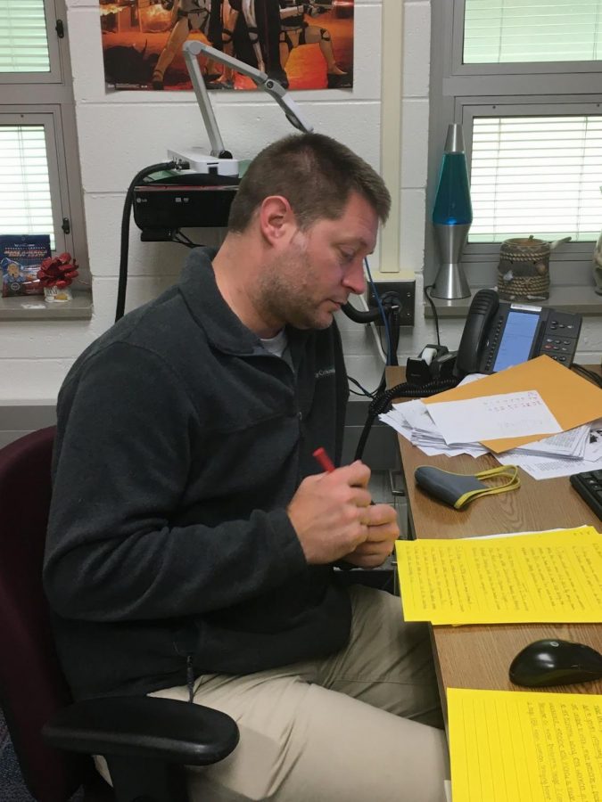 Rho Kappa organizer and sponsor John Carter grades papers for his AP Human Geography class. He said the students in the club will start forming teams this November, to prepare for the Academic WorldQuest competition.
