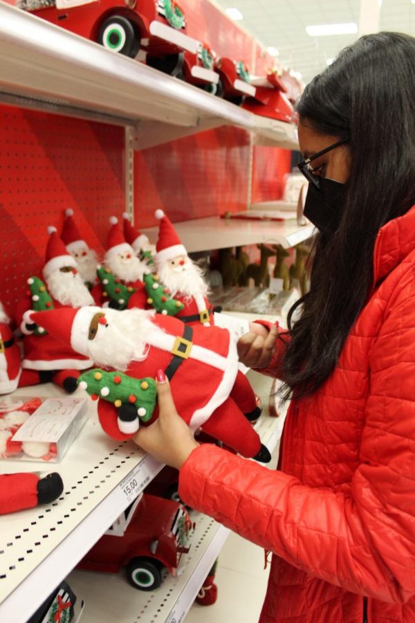 Sophomore Vaishu Majji explores various Christmas candies, decorations and apparel. Majji said she enjoys celebrating Christmas as a secular holiday with her friends and family. “A lot of it is time with family, eating good food, and a lot of lights and presents,” she said.
