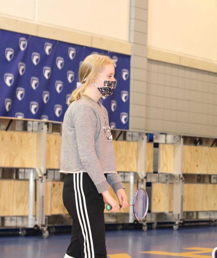 Lauren Tompkins, senior and club member prepares to play a badminton game. Club leader and senior Mark Lee said that badminton is a sport that requires a lot of agility.