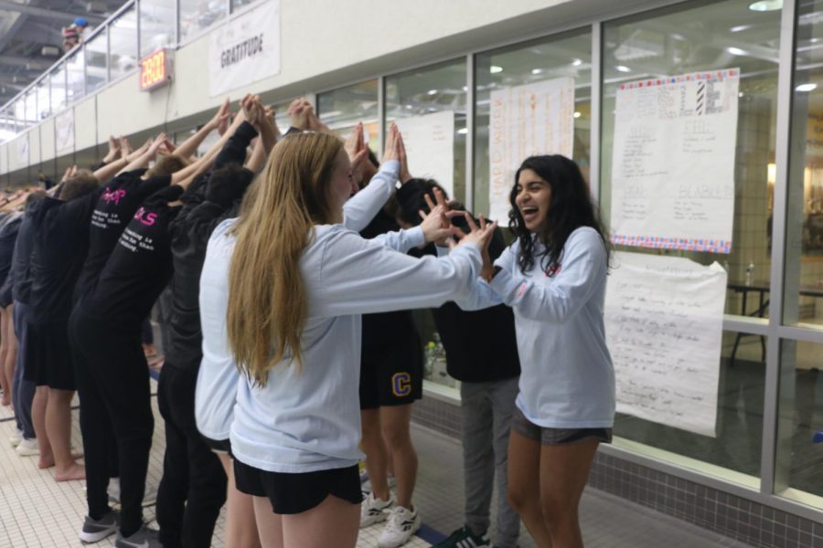 Senior Varsha Chandramouli laughs as
she and other swim team members make
a path to honor senior members. She said
the team provides a support system, but is
not the only thing that defines her.