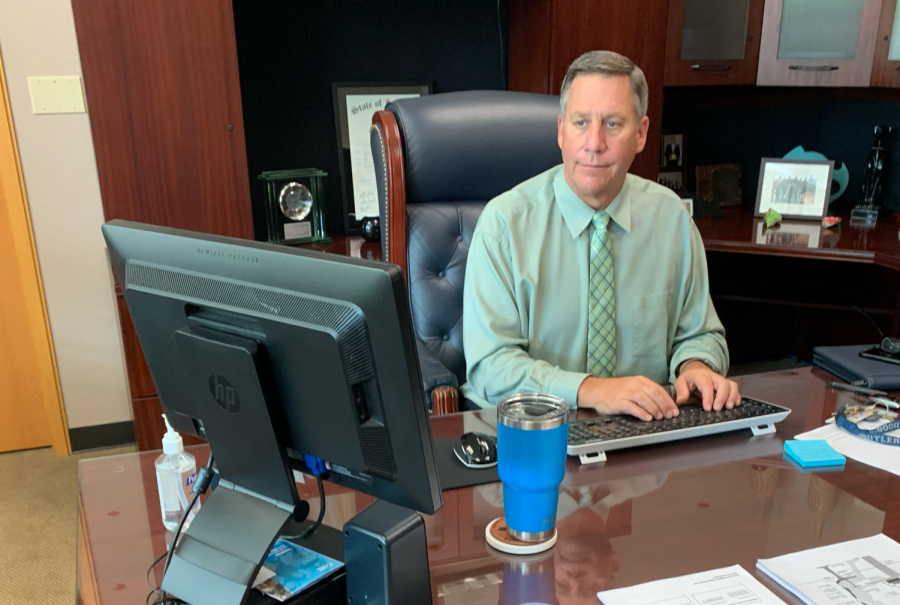  Principal Tom Harmas works at his desk. Harmas said, by updating the way finals work, CHS hopes to prioritize true understanding of content and ensure students are prepared before entering second semester. 