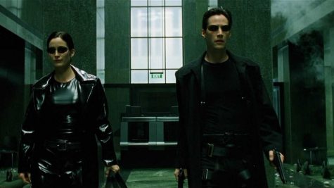 The Matrix” characters Neo and Trinity are shown with weaponry after an action sequence. Played by Keanu Reeves and Carrie-Anne Moss respectively, the actors worked together closely in many scenes.