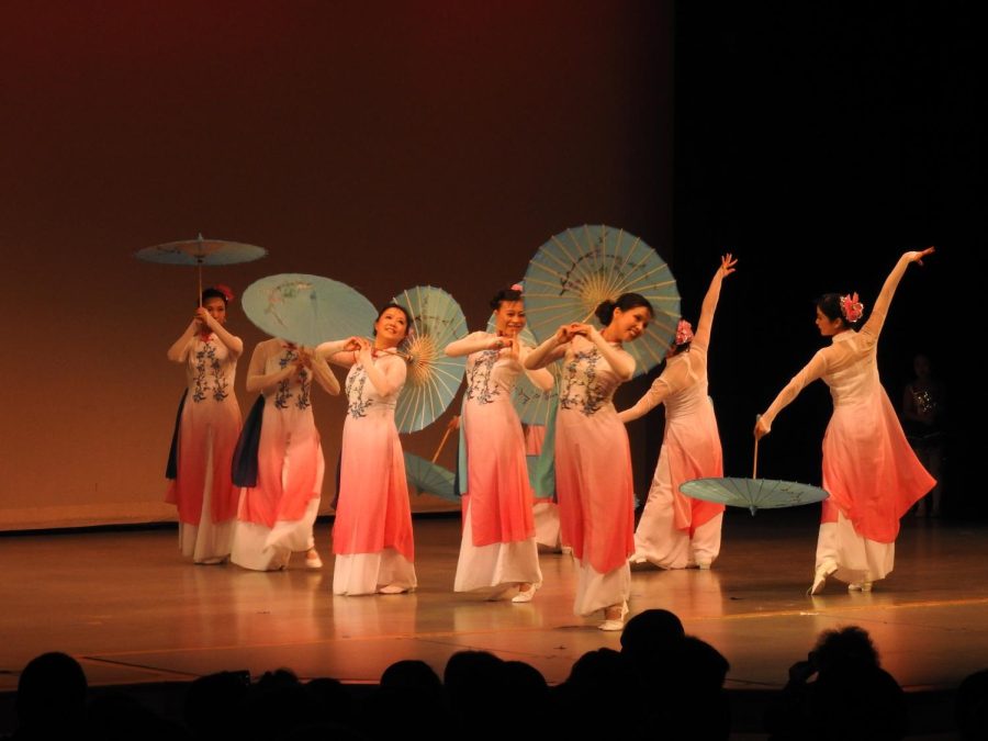 At a Chinese New Year celebration, dancers wear traditional clothing during a performance. They also utilize umbrellas with designs throughout the dance. Wang said her family usually attends local celebrations like this one, but COVID-19 has made in-person gatherings difficult.