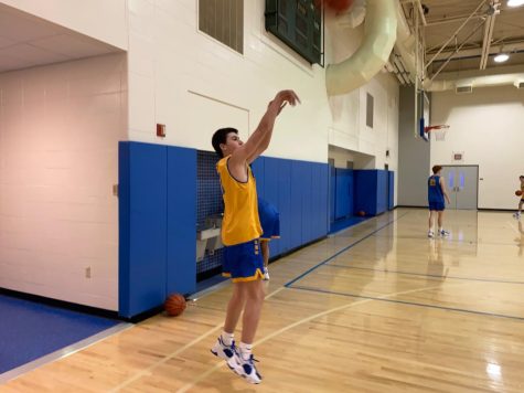  Guard and freshman Alex Couto practices his jump shot during a practice. Head Coach Andrew Foley said the JV basketball team will focus on playing well from the beginning to the end of a game and limiting mistakes as they progress through their season.