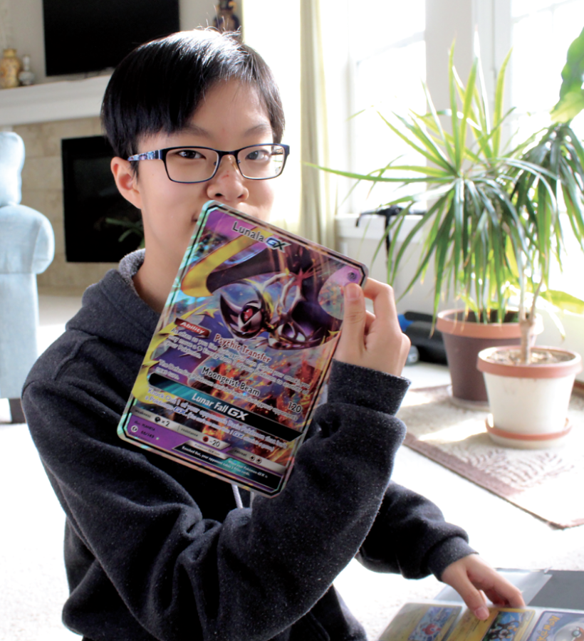 Sophomore Sarah Xie holds up a large Lunala-GX Pokémon card, released in 2016. “I got into Pokémon from my sister who introduced me to the show,” Xie said.