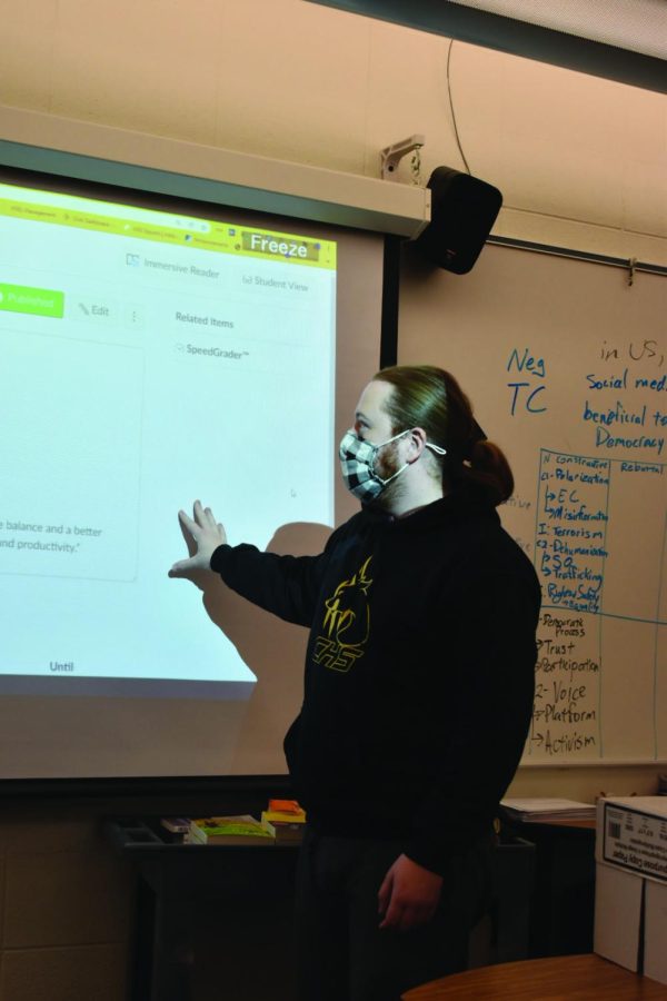 While completing a demonstration for his students, E-sports director Dylan Gentilcore  uses his screen and projector. Gentilcore said he thought VR would take a more significant role in education in the future, as demonstrated by  the rapidly increasing use of technology in classrooms. He said even today’s VR can engage people’s brains by forcing them to problem-solve in games.