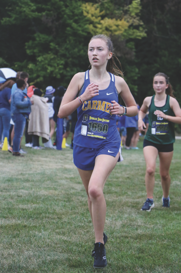 Mila Bonewitz, cross-country runner and sophomore, looks ahead during a race. Bonewitz also participates in wrestling and track.