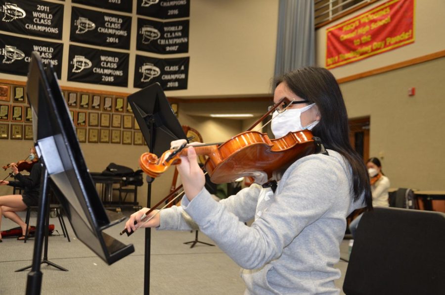 Rachel Wu, member of Symphony Orchestra and sophomore, plays a piece during after-school rehearsal. According to Wu, “I am really excited to perform at Carnegie Hall.”