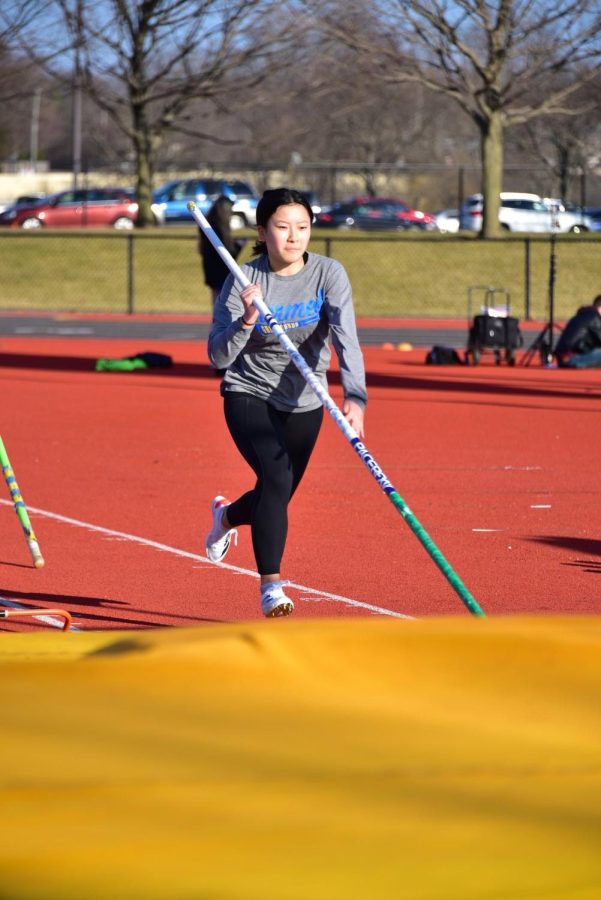 Julia Dong, pole vaulter and junior, prepares to jump at practice. Dong said pole vault is good for strength training and exercise.