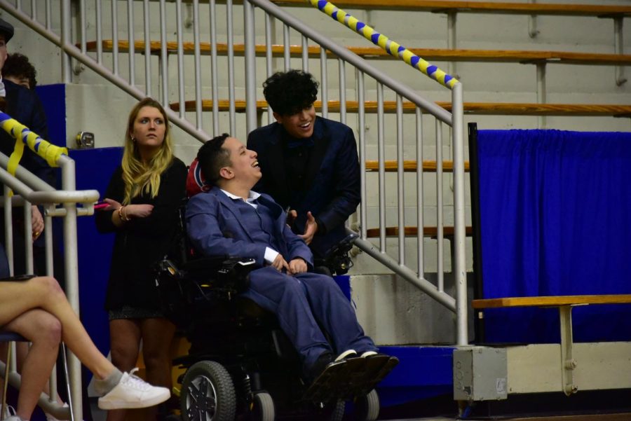 Seniors Jesus Andres Sanchez (left) and Daniyal Sher (right) laugh together during Mr. Carmel 2022. Andres escorted Sher at the event, dedicated to raising money for Special Olympics Indiana.