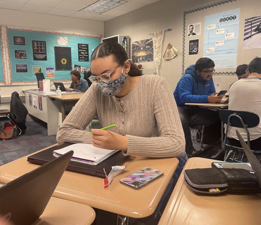 As she volunteers as a tutor during the NHS peer tutoring sessions, senior and NHS member Anna Hopson takes notes. Students interested in receiving academic help during the free NHS peer tutoring sessions should visit E107, NHS sponsor Allison Malloy’s room, during SSRT. 