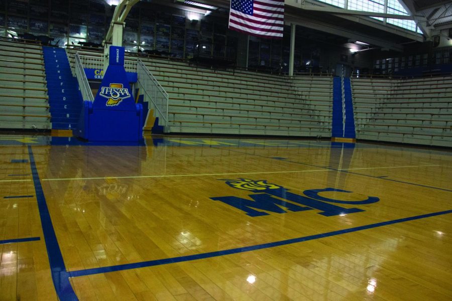 The logo of the Metropolitan Interscholastic Conference (MIC) on the basketball court in the varsity gym. Carmel became an independent school after the Hoosier Crossroads Conference declined to allow it and Center Grove to join.