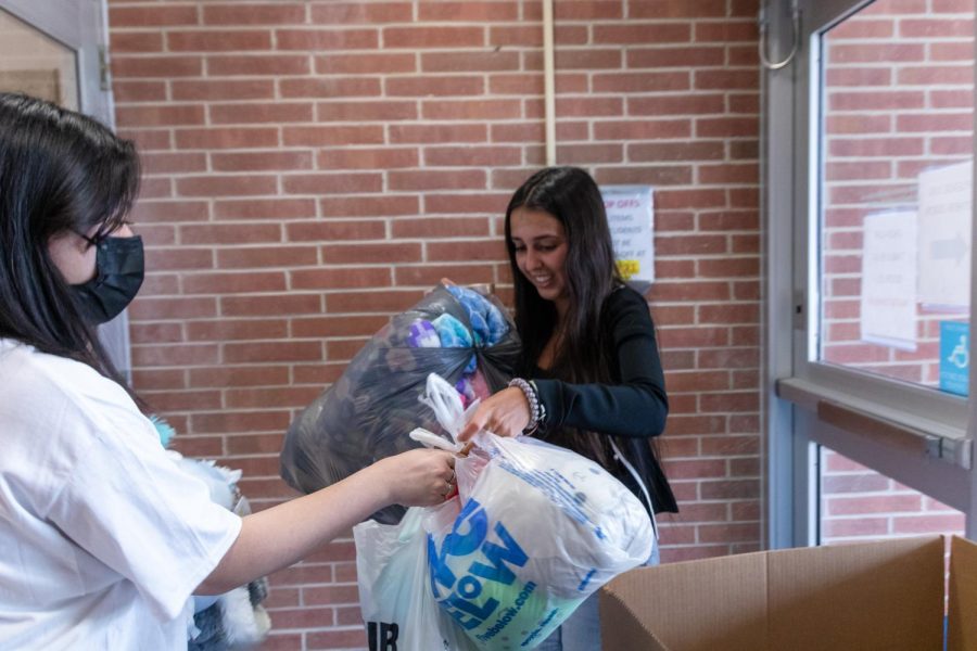 Junior Parisa Shirani collects stuffed animals from a donation box at door 4 during a Carmel UNICEF club
meeting on Tuesday, April 12th. Carmel UNICEF started a
donation drive for Ukranian children displaced by the war
in Ukraine from March 23rd to April 22nd.