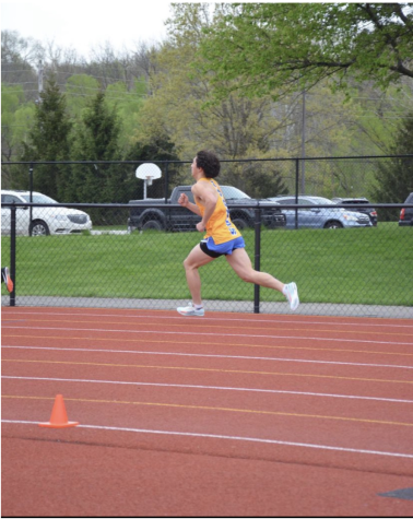 Adrien Cadio, track and field runner and sophomore, runs in the Carmel Invitational. Coach Altevogt said that the team will be top contender for the State championship in early June.
