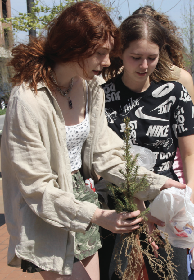 Sophomores Ella Lipnik and Sara Standish give away free tree saplings as a part of the 10,000 Trees in Carmel Initiative. This event, held at Midtown Plaza, was organized by the Green Action Club.