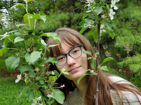 Junior Natasha Tikhomirova poses in front of her self-made garden. Tikhomirova said she first got into gardening after planting an apple tree and enjoying the process. 