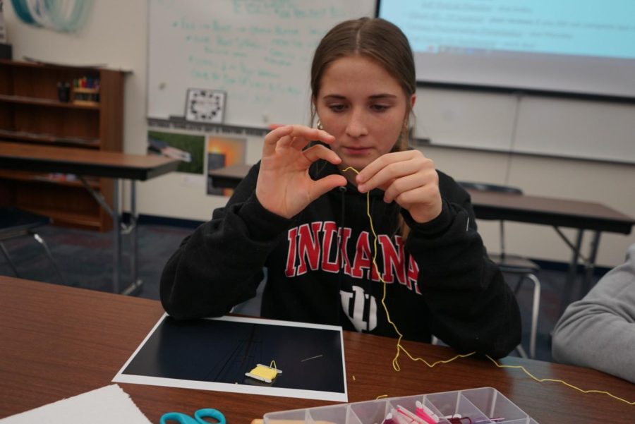 Sophomore Veronica Stryzynski works on her “Hands On” Photography assignment in Digital Photography on Tuesday, Mar, 14 This assignment requires the photographer to choose one of their best photos, print it off then, the student will manipulate the photo by hand as shown.