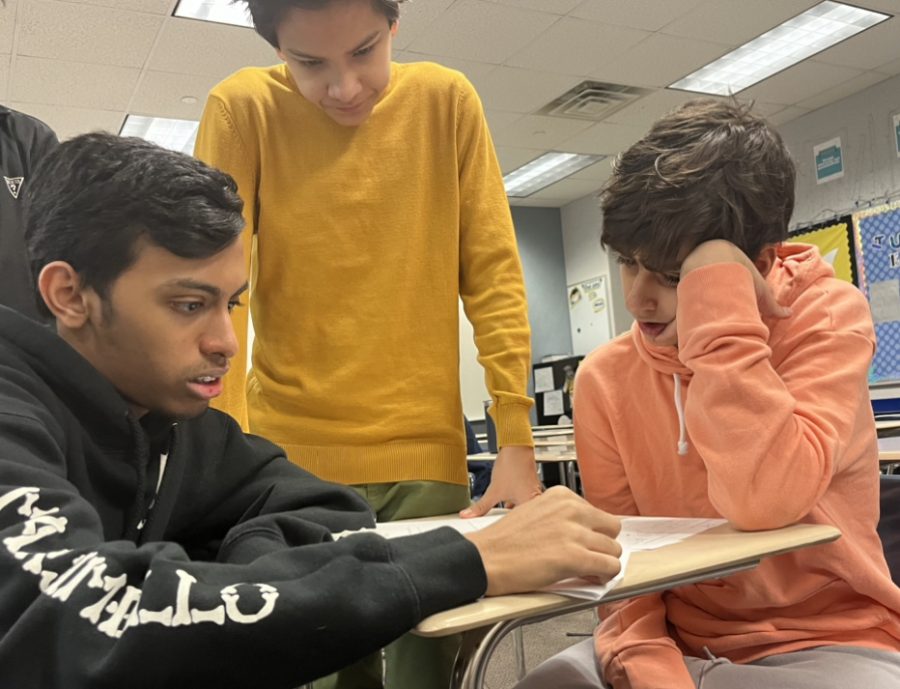 Rashab Shetty (left), Zaid Al-Mittah (right), and Oguz Ulusoy review for their geometry test on Jan. 23rd. The class is learning about parallelograms, and how to prove if a shape is a parallelogram, or not. The group collaboration in the class helps all students understand their topics better when they share their thoughts on how to solve each problem.