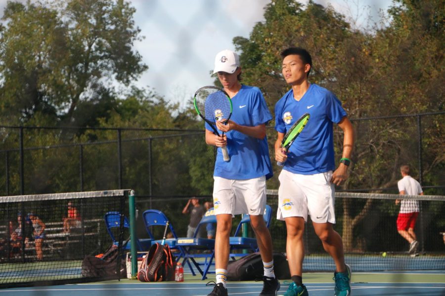 Junior and tennis player Jonathan Yang walks alongside his doubles partner, junior Braedon McIntyre during the match against North Central on Sept. 1. Yang explained how although an individual sport, tennis involves a lot of team cooperation. 