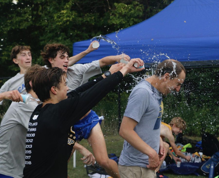 The Men’s Cross Country team celebrates their victory in Sep. 3. The Team throws water on their coach Colin Altevog after they won first place at the Brownsburg Invitational.