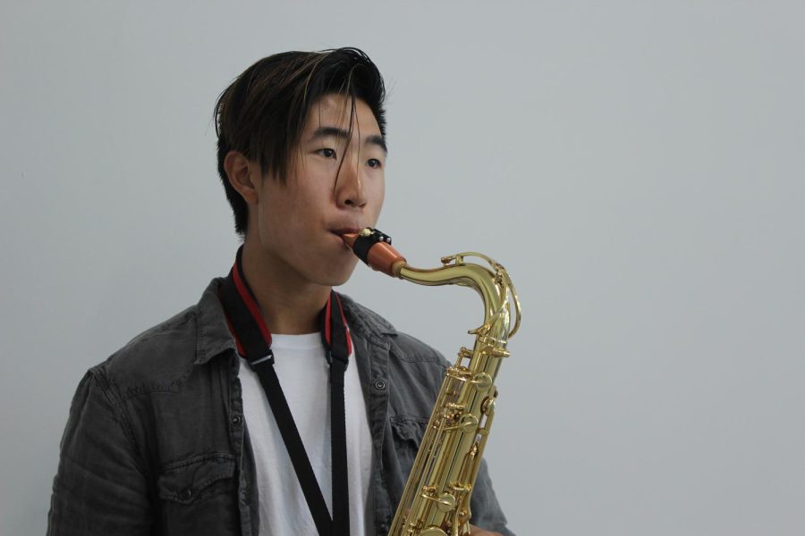 Senior George Huang plays his tenor saxophone. Huang currently plays multiple instruments and enjoys exploring different genres of music.